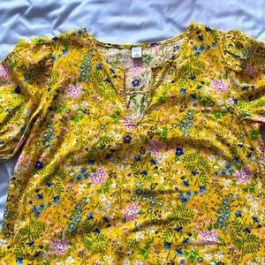 Shirt is yellow and floral